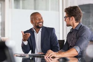 two men discussing healthcare business consultant services